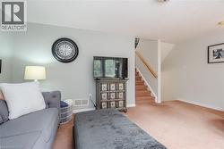 Carpeted main level featuring light gray painted walls and white trim - 