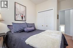 Bedroom featuring painted walls, carpet flooring, bi-fold closet doors, and recessed lighting in the hallway - 