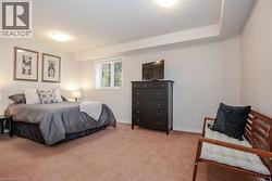 Carpeted room featuring a single window, white baseboards, and a neutral wall color - 
