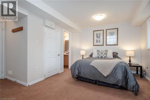 Carpeted bedroom featuring recessed lighting, a window, and a paneled door - 38 David Bergey Drive, Kitchener, ON - Indoor Photo Showing Bedroom