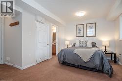 Carpeted bedroom featuring recessed lighting, a window, and a paneled door - 