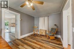 Room featuring wood-finish flooring and a ceiling fan with integrated lighting - 