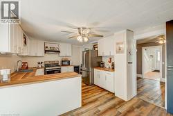 Kitchen featuring white cabinetry and wood-finish countertops - 
