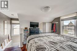 Room with sloped ceilings and two windows - 