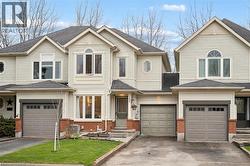 Light-toned siding exterior with an arched window accent and a single-car garage - 