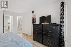 Light wood-finish flooring extending into open doorways - 