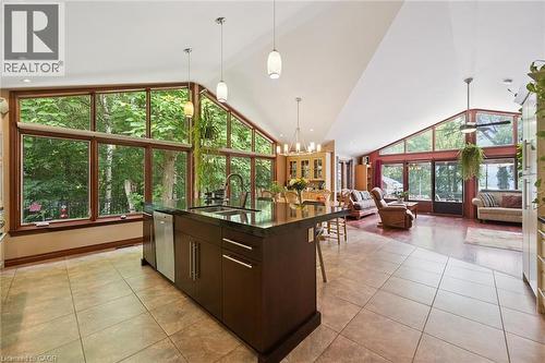 Open-concept living area with a vaulted ceiling and expansive window walls - 410 Avenue Road, Cambridge, ON - Indoor