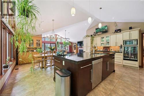 Open-concept kitchen featuring a large central island with an undermount sink dual SST sink, integrated SST Bosch dishwasher, Quartz butcher style countertop - 410 Avenue Road, Cambridge, ON - Indoor Photo Showing Kitchen With Double Sink With Upgraded Kitchen