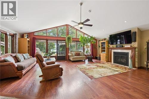 Spacious living area featuring wood-finish flooring, a vaulted ceiling with a ceiling fan, and recessed lighting - 410 Avenue Road, Cambridge, ON - Indoor Photo Showing Living Room With Fireplace