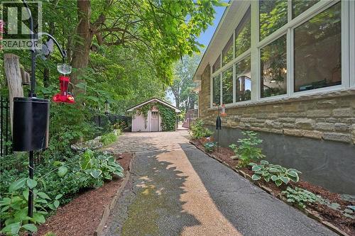 Pass through driveway to the workshop features beautifully landscaped gardens with irrigation system - 410 Avenue Road, Cambridge, ON - Outdoor
