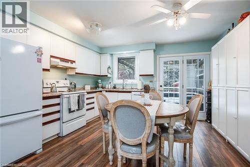 Kitchen featuring white cabinetry, wood-finish flooring, and light blue wall tones - 67 Pinemeadow Crescent, Waterloo, ON - Indoor