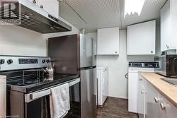 Compact kitchen and laundry area featuring stainless steel appliances - 