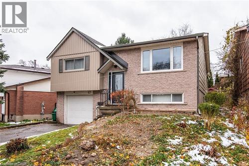 Split-level residence featuring a brick facade and vertical siding - 67 Pinemeadow Crescent, Waterloo, ON - Outdoor