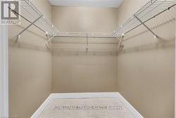 Primary bedroom walk-in closet - 
