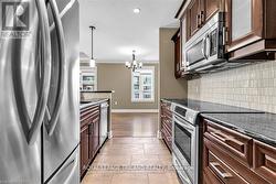 Granite Countertops with rich cabinetry - 