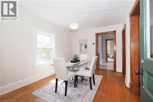 Hardwood flooring throughout featuring white trim, a single window, and a contemporary ceiling light fixture - 148 Tiffany Street, Cambridge, ON - Indoor Photo Showing Dining Room