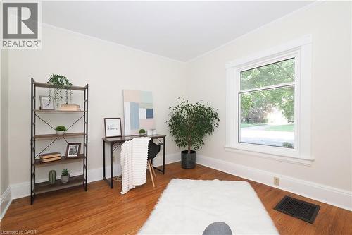 Bright interior space featuring polished wood-finish flooring, white baseboards, and crown molding - 148 Tiffany Street, Cambridge, ON - Indoor Photo Showing Other Room