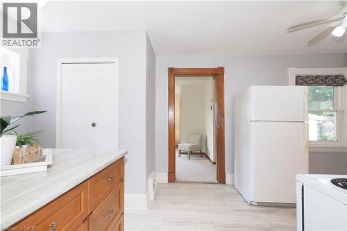 Kitchen featuring wood-finish cabinetry, light-toned countertop, and light gray walls - 148 Tiffany Street, Cambridge, ON - Indoor