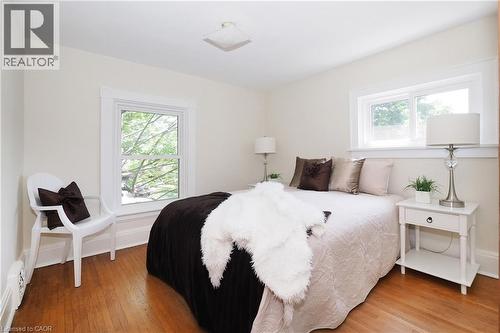 Bright room featuring wood-finish flooring and multiple windows - 148 Tiffany Street, Cambridge, ON - Indoor Photo Showing Bedroom
