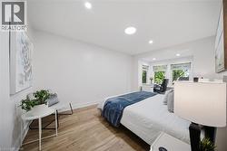 Bedroom featuring wood-finish flooring, recessed lighting. - 
