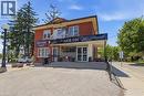 Brick exterior featuring multiple windows and a second-story balcony - 744 Queen Street S, Kitchener, ON  - Outdoor 