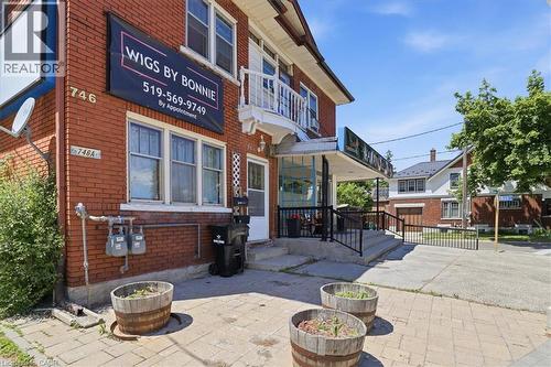 Red brick commercial building with multiple windows - 744 Queen Street S, Kitchener, ON - Outdoor