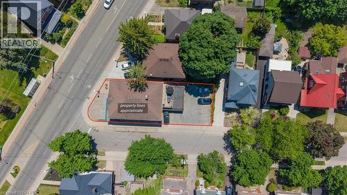 Aerial view of a commercial property with a brown-roofed building and an adjacent paved parking area - 744 Queen Street S, Kitchener, ON - Outdoor With View