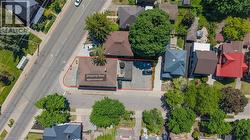 Aerial view of a commercial property with a brown-roofed building and an adjacent paved parking area - 
