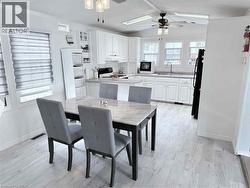 Open-concept kitchen and dining area featuring light-toned wood-finish flooring - 
