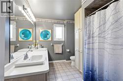 Bathroom featuring a dual vanity with integrated rectangular sinks and chrome faucets - 