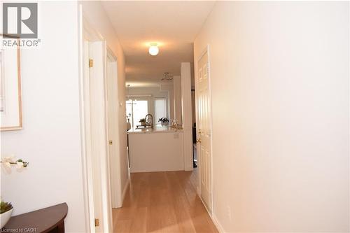 Hallway featuring light wood-finish flooring, white walls, and bright overhead lighting - 28 Lemon Grass Street, Kitchener, ON - Indoor Photo Showing Other Room