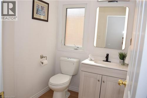Contemporary vanity with a rectangular undermount sink, solid surface countertop, and matte black faucet - 28 Lemon Grass Street, Kitchener, ON - Indoor Photo Showing Bathroom