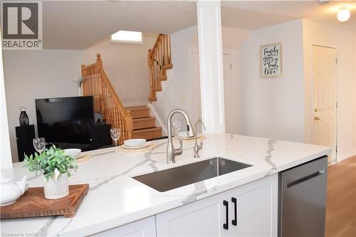 Kitchen island featuring a stainless steel undermount sink and a brushed nickel faucet - 28 Lemon Grass Street, Kitchener, ON - Indoor Photo Showing Kitchen