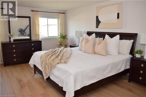 Light wood-finish flooring complements white walls - 28 Lemon Grass Street, Kitchener, ON - Indoor Photo Showing Bedroom