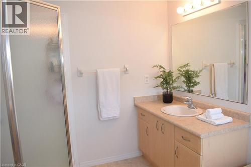 Bathroom featuring a wood-finish vanity with an integrated sink and beige countertop - 28 Lemon Grass Street, Kitchener, ON - Indoor Photo Showing Bathroom