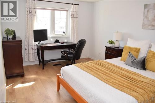 Bright room featuring a large window, light wood-finish flooring, and white baseboards - 28 Lemon Grass Street, Kitchener, ON - Indoor Photo Showing Bedroom