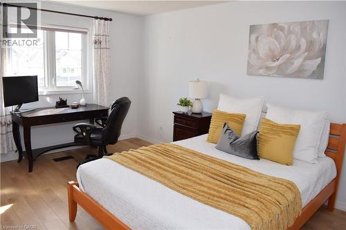 Hardwood-finish flooring extending throughout the room - 28 Lemon Grass Street, Kitchener, ON - Indoor Photo Showing Bedroom