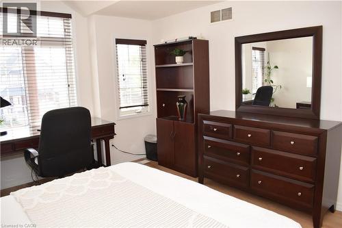 Light-filled room featuring white walls, multiple windows with blinds, and white trim - 28 Lemon Grass Street, Kitchener, ON - Indoor Photo Showing Other Room
