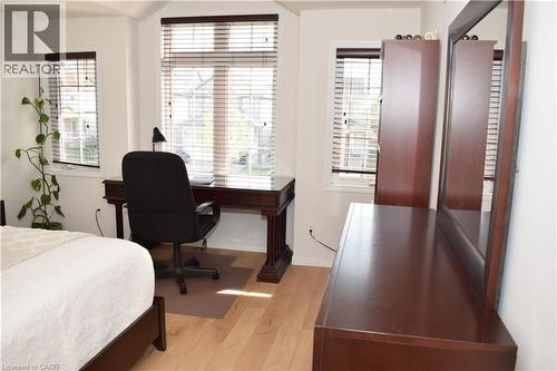 Hardwood-style flooring throughout, with multiple windows featuring horizontal blinds - 28 Lemon Grass Street, Kitchener, ON - Indoor Photo Showing Office