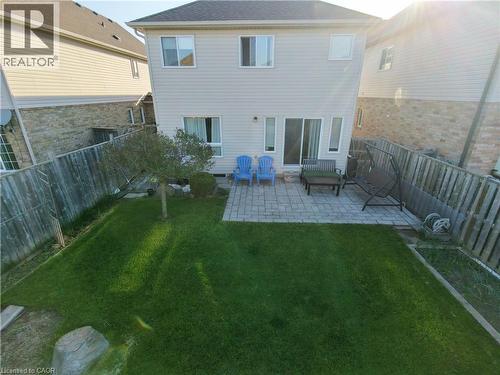 Expansive backyard featuring a manicured lawn, a paved patio, and a mature tree - 28 Lemon Grass Street, Kitchener, ON - Outdoor With Deck Patio Veranda With Exterior