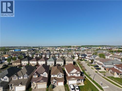 Residential neighborhood featuring a variety of single-family homes with distinct architectural styles, asphalt shingle roofs, and attached garages - 28 Lemon Grass Street, Kitchener, ON - Outdoor With View