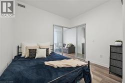 Bright bedroom space with wood-finish flooring - 