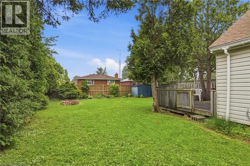 Expansive lawn area with a stone fire pit - 834 Mohawk Road E, Hamilton, ON - Outdoor