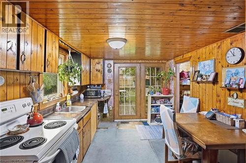 Kitchen featuring wood paneling, wood-finish cabinetry, and French doors - 834 Mohawk Road E, Hamilton, ON - Indoor Photo Showing Other Room