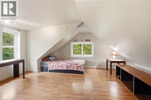 Attic room featuring light wood-finish flooring, white walls, and a sloped ceiling - 834 Mohawk Road E, Hamilton, ON - Indoor Photo Showing Bedroom