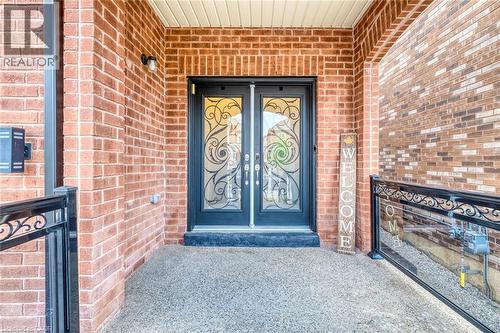 Double entry doors featuring ornate wrought iron and frosted glass panels - 598 Bessborough Drive, Milton, ON -  With Fireplace