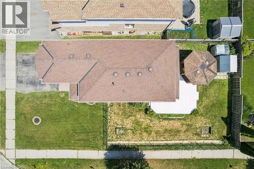 Property featuring a brown shingle roof, paved driveway, and a white patio - 71 Peach Blossom Crescent, Kitchener, ON 