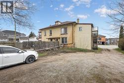 Brick exterior with multiple windows and a rear wooden fire escape - 