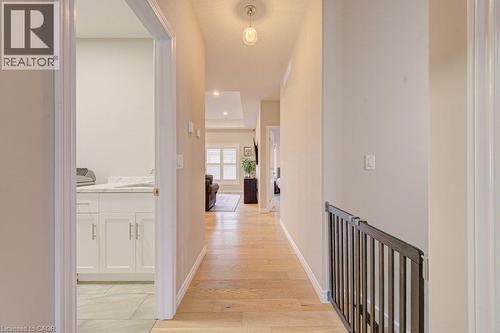 Hallway with wood-finish flooring, recessed lighting, and a visible railing - 15 Matheson Crescent, Innerkip, ON - Indoor Photo Showing Other Room