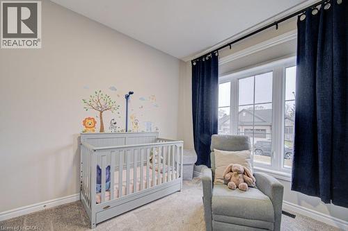Bright room featuring neutral walls, carpeting, and a large window with deep blue drapes - 15 Matheson Crescent, Innerkip, ON - Indoor Photo Showing Bedroom